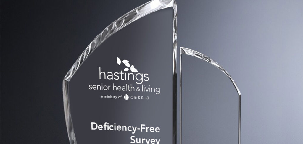 Glass award engraved with the Hastings Senior Health & Living logo and the words “Deficiency-Free Survey.”